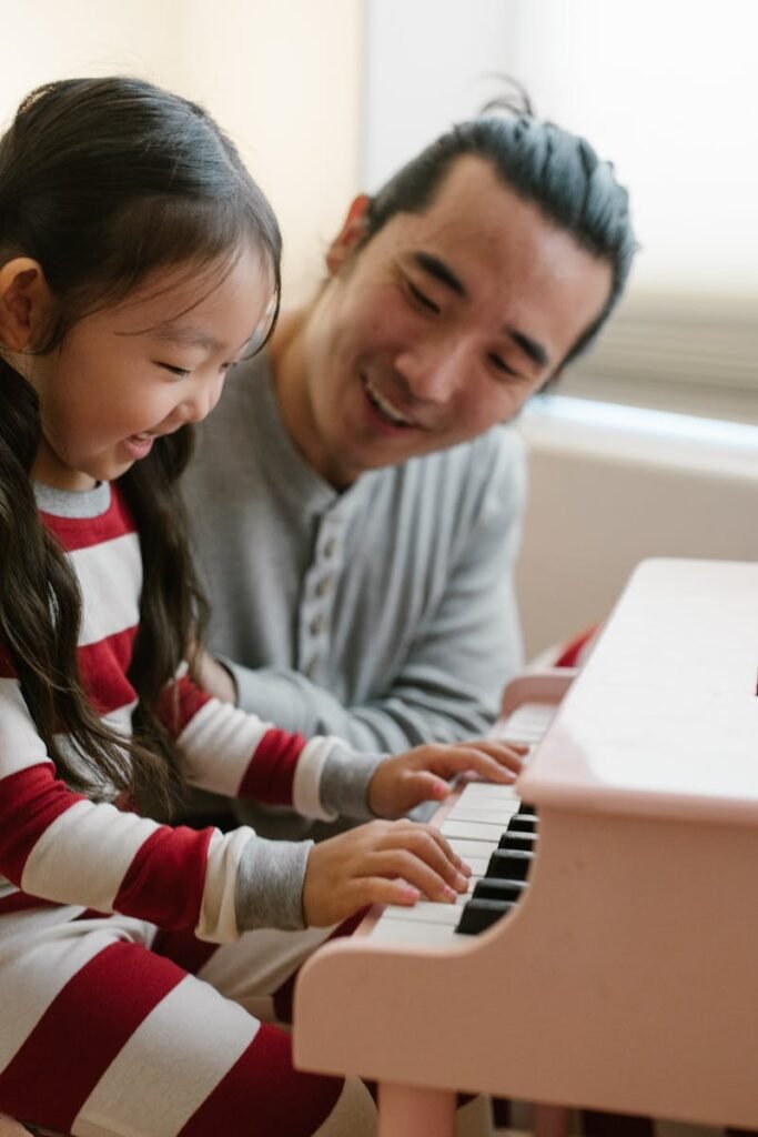 pexels-photo-10565596-10565596 Father and daughter practicing what she learned at her piano lesson