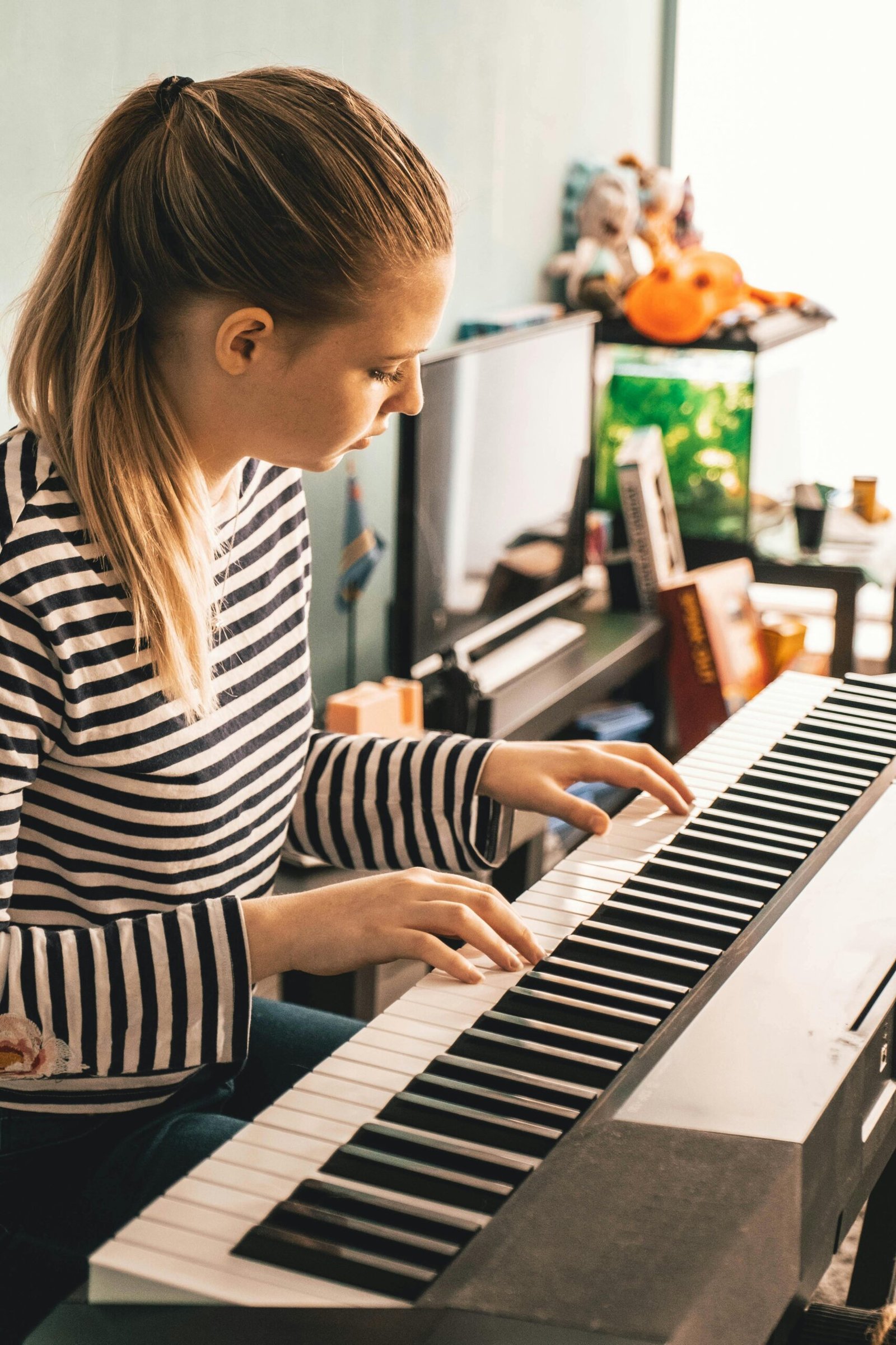 pexels-photo-2592179-2592179 Young girl practicing what she learned at piano lessons