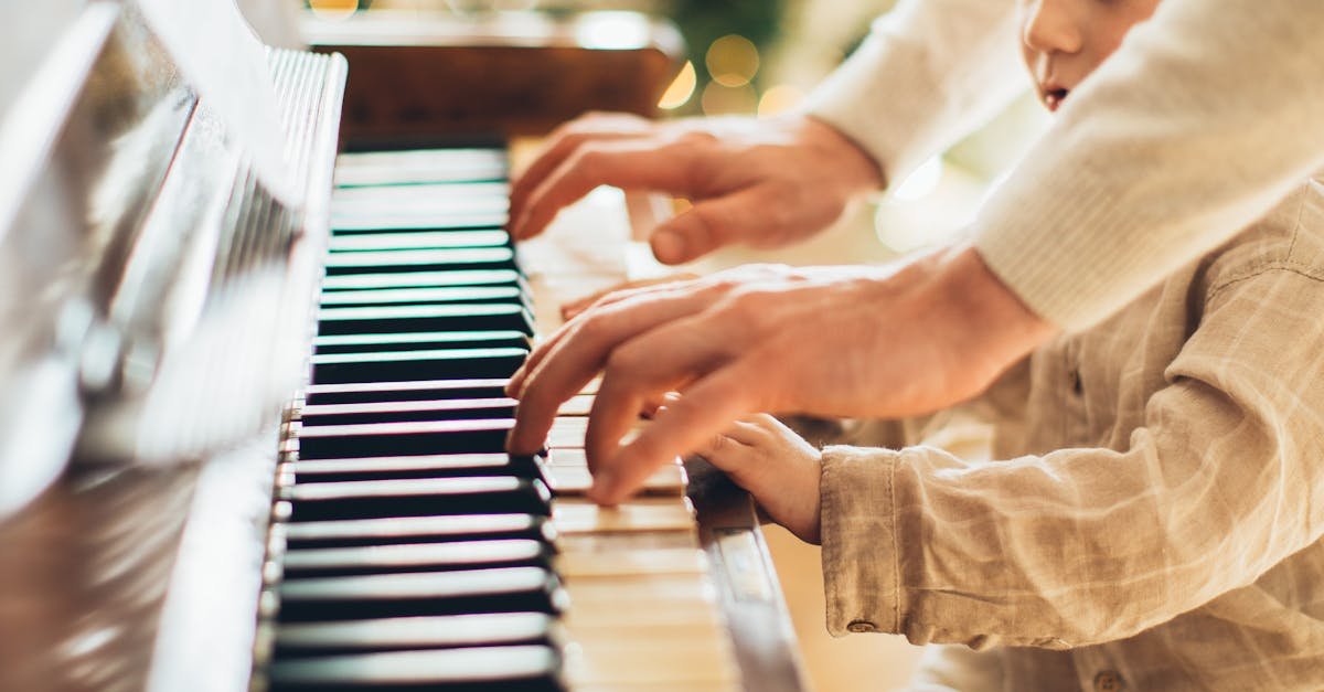 pexels-photo-5859812-5859812 Young boy playing piano with an adult in a duet at piano lessons