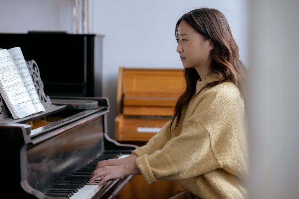 pexels-photo-6647444-6647444 Adult female practicing the piano