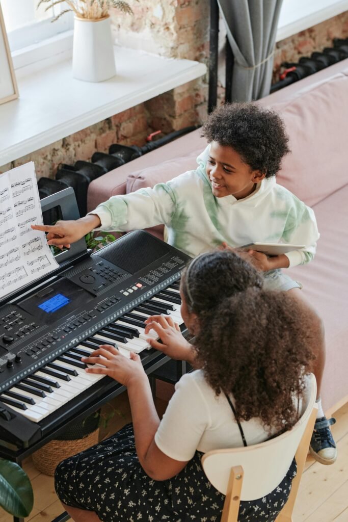 pexels-photo-7714269-7714269 Two kids working on music education with piano lessons